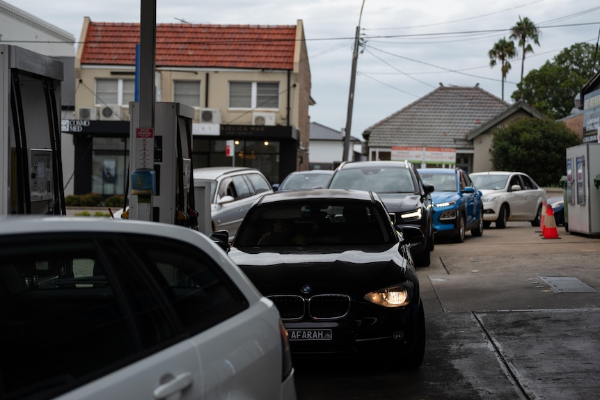 Cars pile into a service station in Sydney on Tuesday.