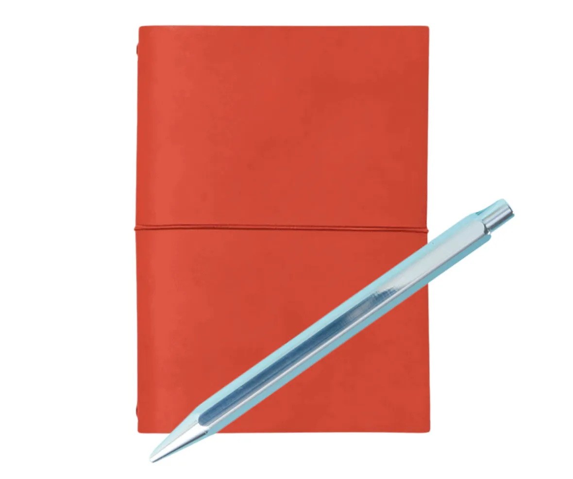 Red notebook with a blue pen diagonally across it.