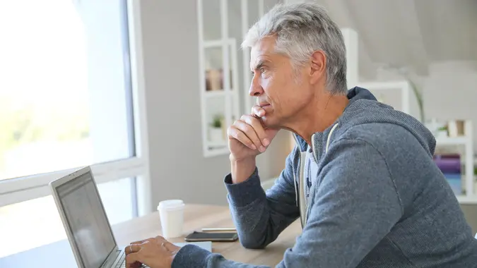 Senior thinking about his finances, investments, retirement plans and other money considerations.