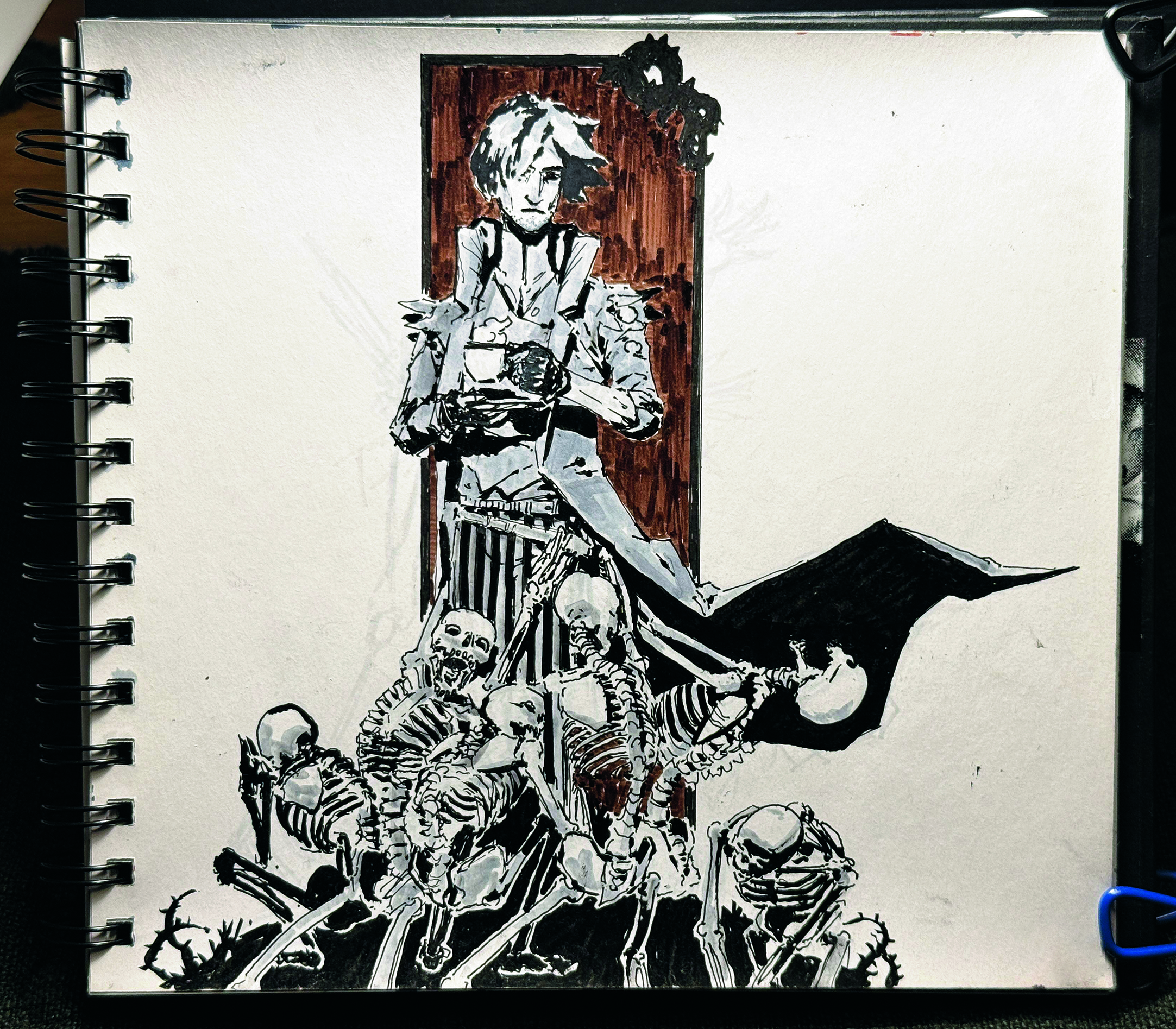 A sketchbook page showing a character holding a cup of tea amid a mound of skeletons