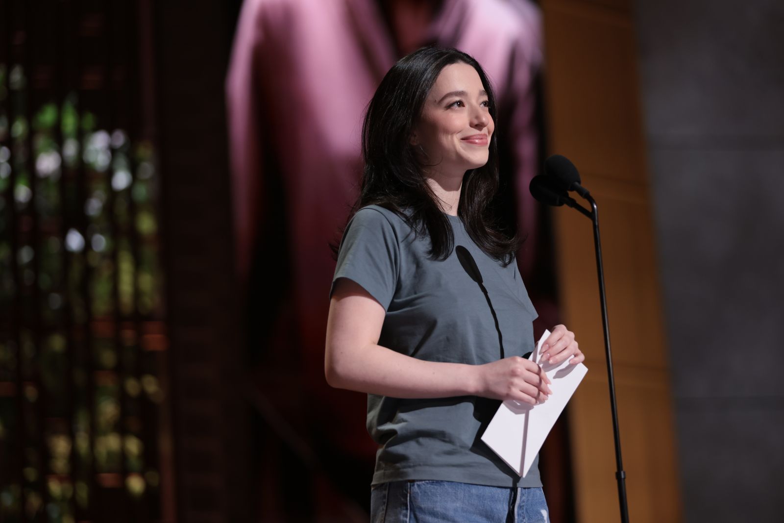 Image may contain Mikey Madison Adult Person Head Face Happy Smile Crowd Electrical Device Microphone and Audience