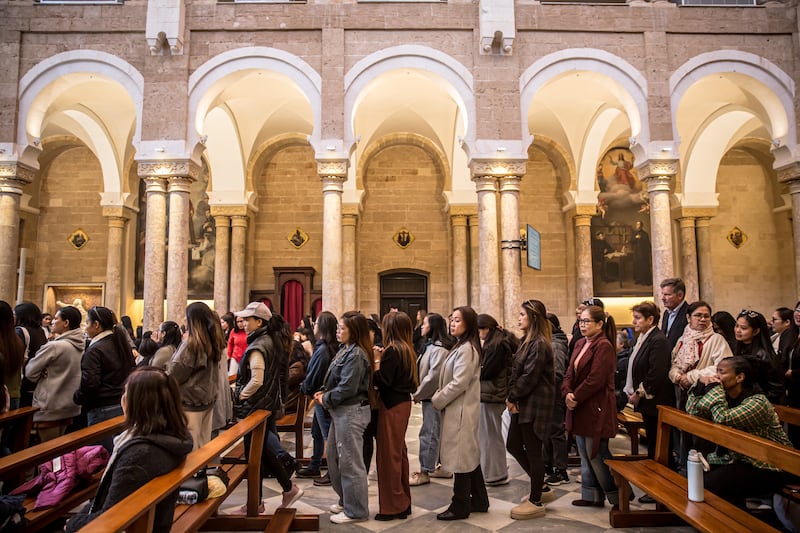 Mass goers queue for Communion at St Joseph's Catholic Church in Monot. Photograph: Sally Hayden