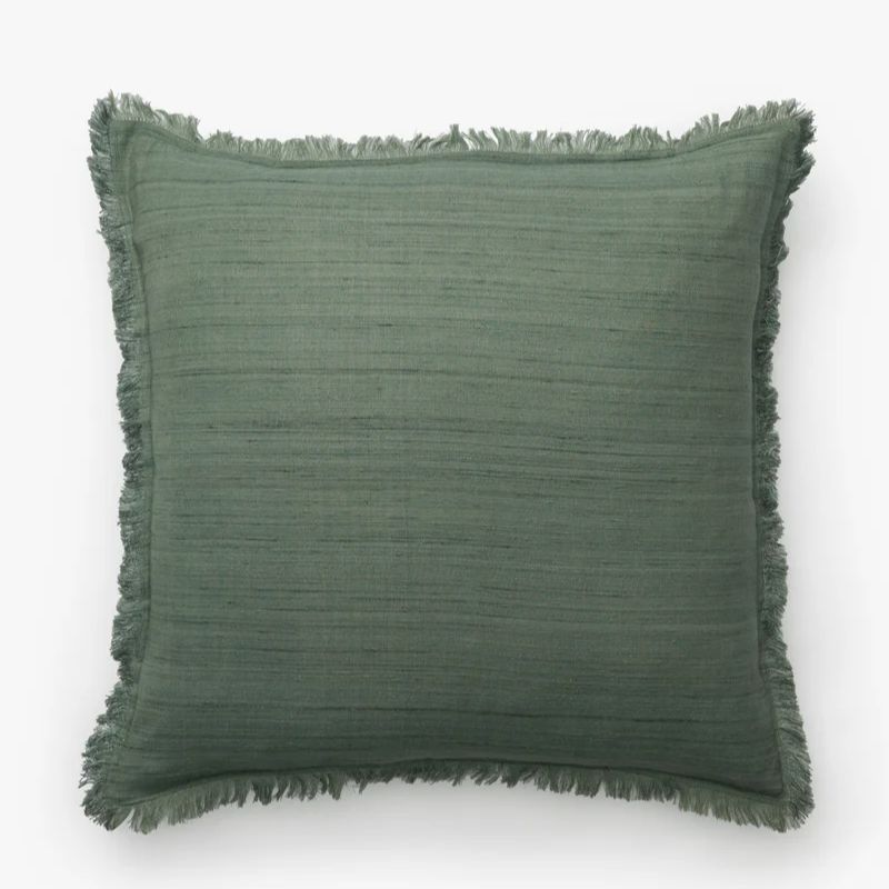 teal cushion with frayed edge