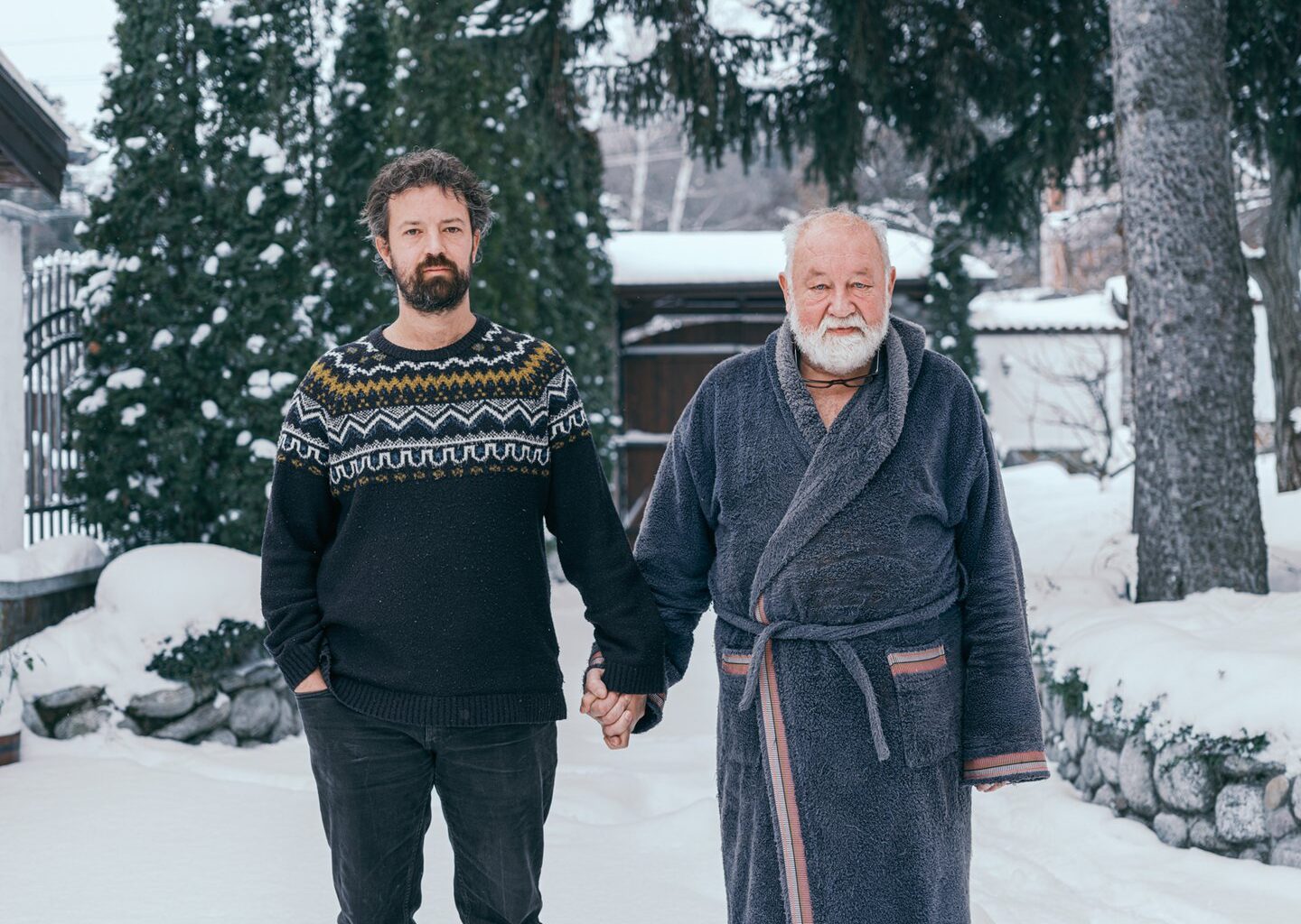 Valery Poshtarov’s portraits of fathers and sons holding hands is a study of “what remains unsaid between men”