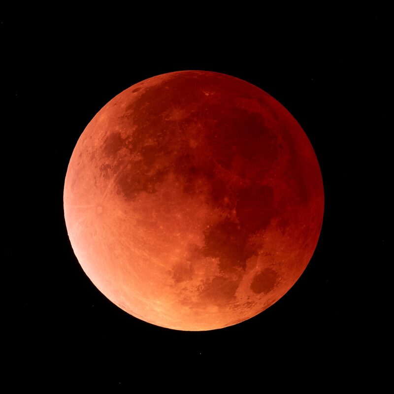 The moon looks deep red on the right side and light red on the left side.