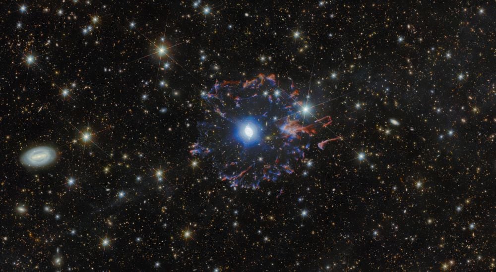 Euclid's wide field of view places the Cat's Eye Nebula in context. While it doesn't put the nebula's internal structure on display as well as other telescopes, it shows a halo of clumps and streamers of gas moving rapidly away from the nebula. This halo was ejected long ago, before the Wolf-Rayet star at the center of it all ejected the gas shell that makes up the nebula itself. Image Credit: ESA/Hubble & NASA, ESA Euclid/Euclid Consortium/NASA/Q1-2025, J.-C. Cuillandre & E. Bertin (CEA Paris-Saclay), Z. Tsvetanov. Licence: CC BY-SA 3.0 IGO or ESA Standard Licence
