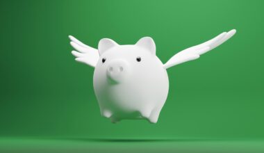 white piggy bank with wings on green background