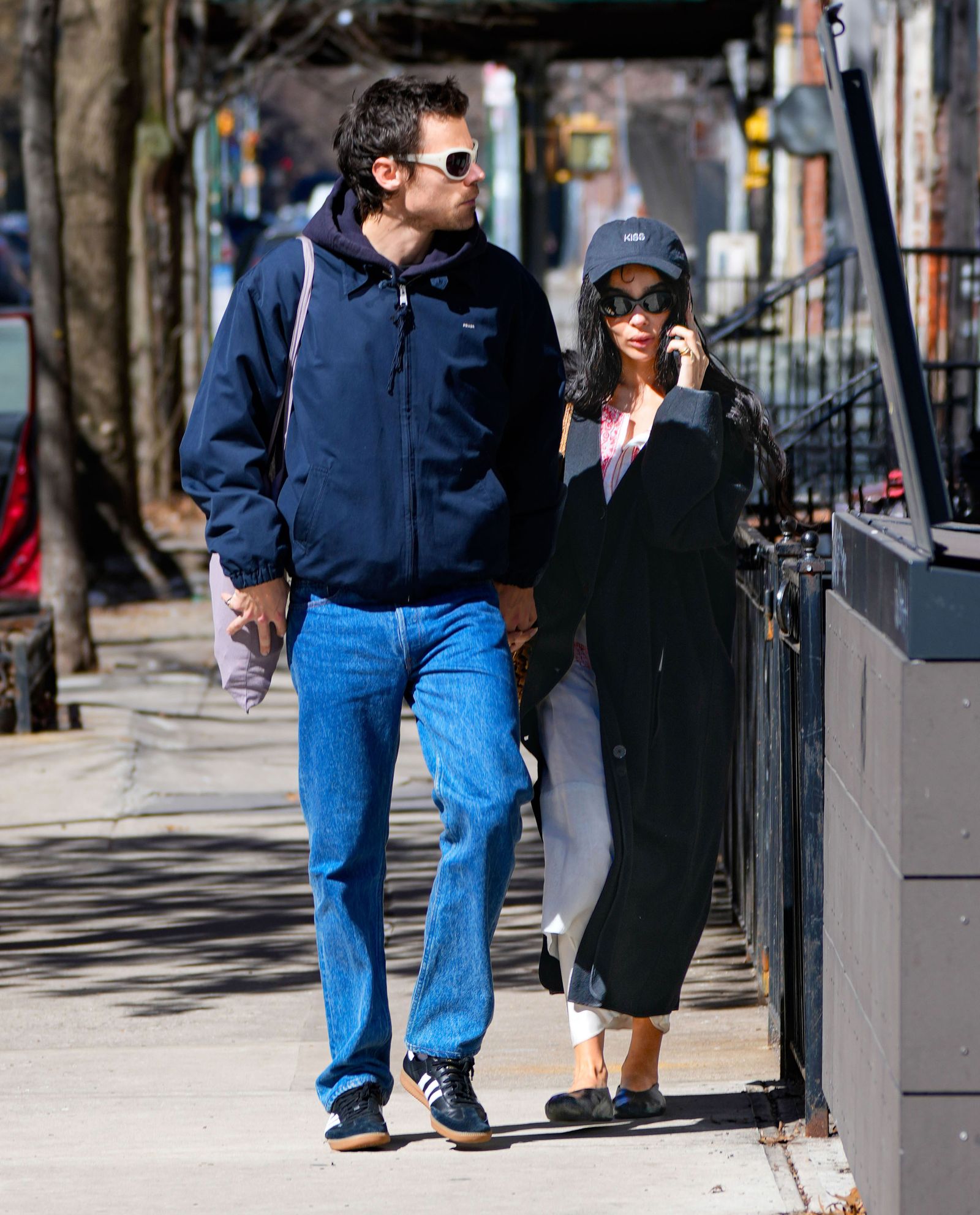 Image may contain Harry Styles Zoë Kravitz Clothing Pants Pedestrian Person Jeans Coat Adult Hoodie and Knitwear