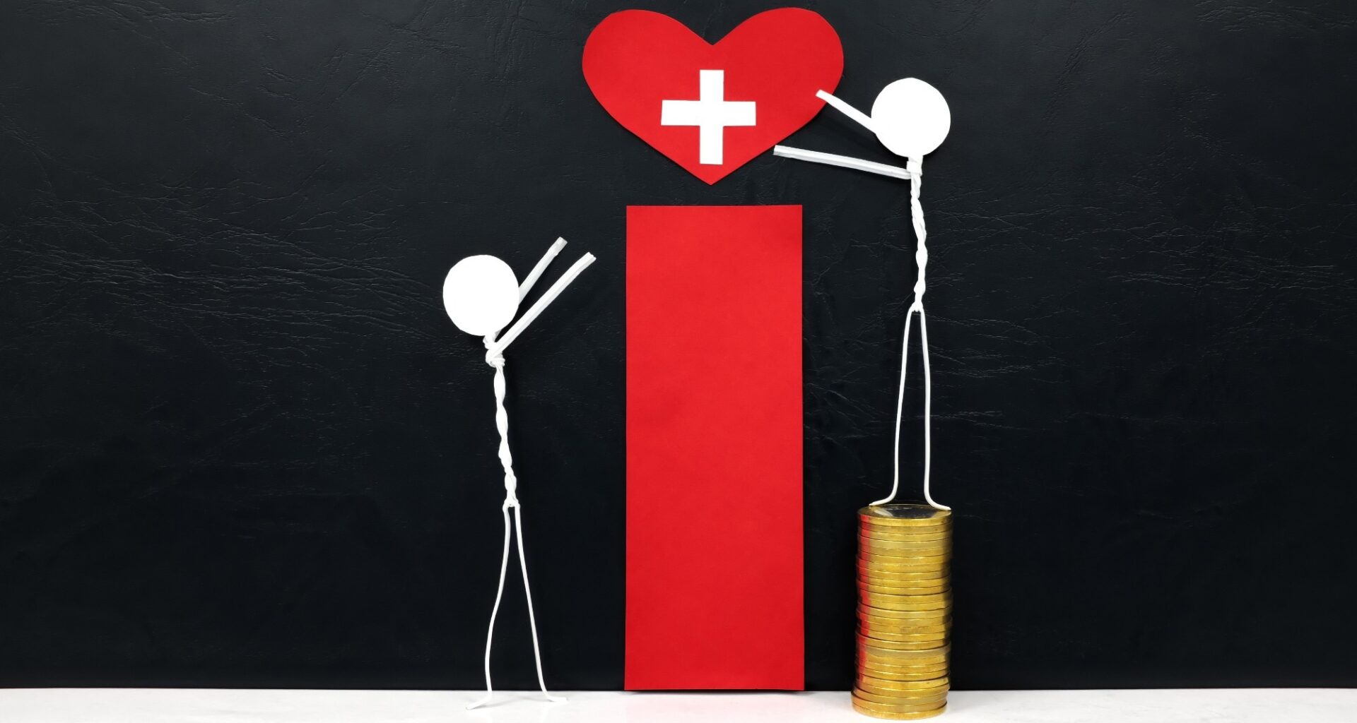 Stick man figure reaching for a red heart shape with cross cutout while stepping on stack of coins. Another stick figure not stepping on coins is unable to reach the heart