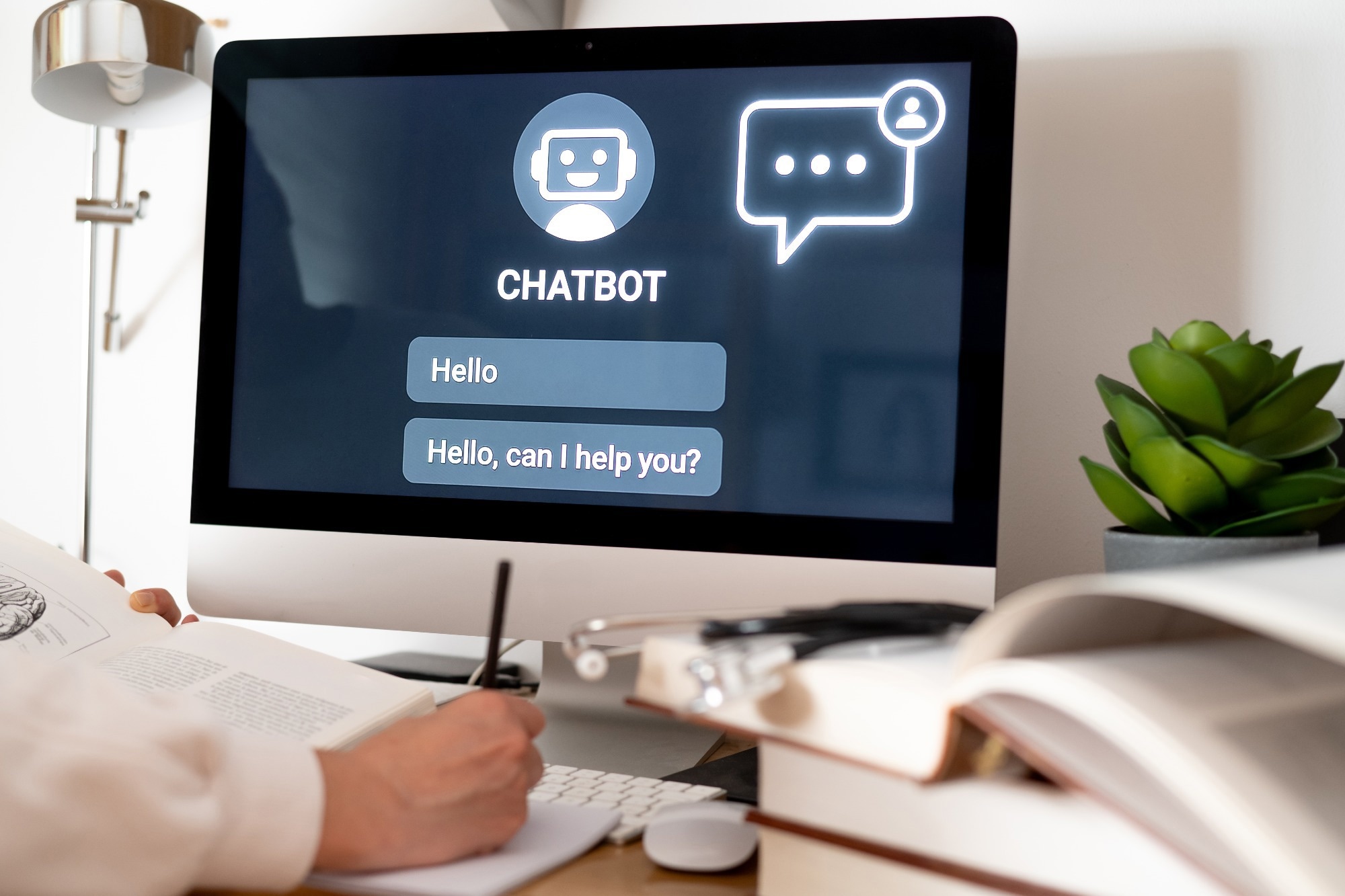 Medical student is taking notes while using an ai-powered chatbot on a computer, enhancing learning and exploring future possibilities of healthcare with technology