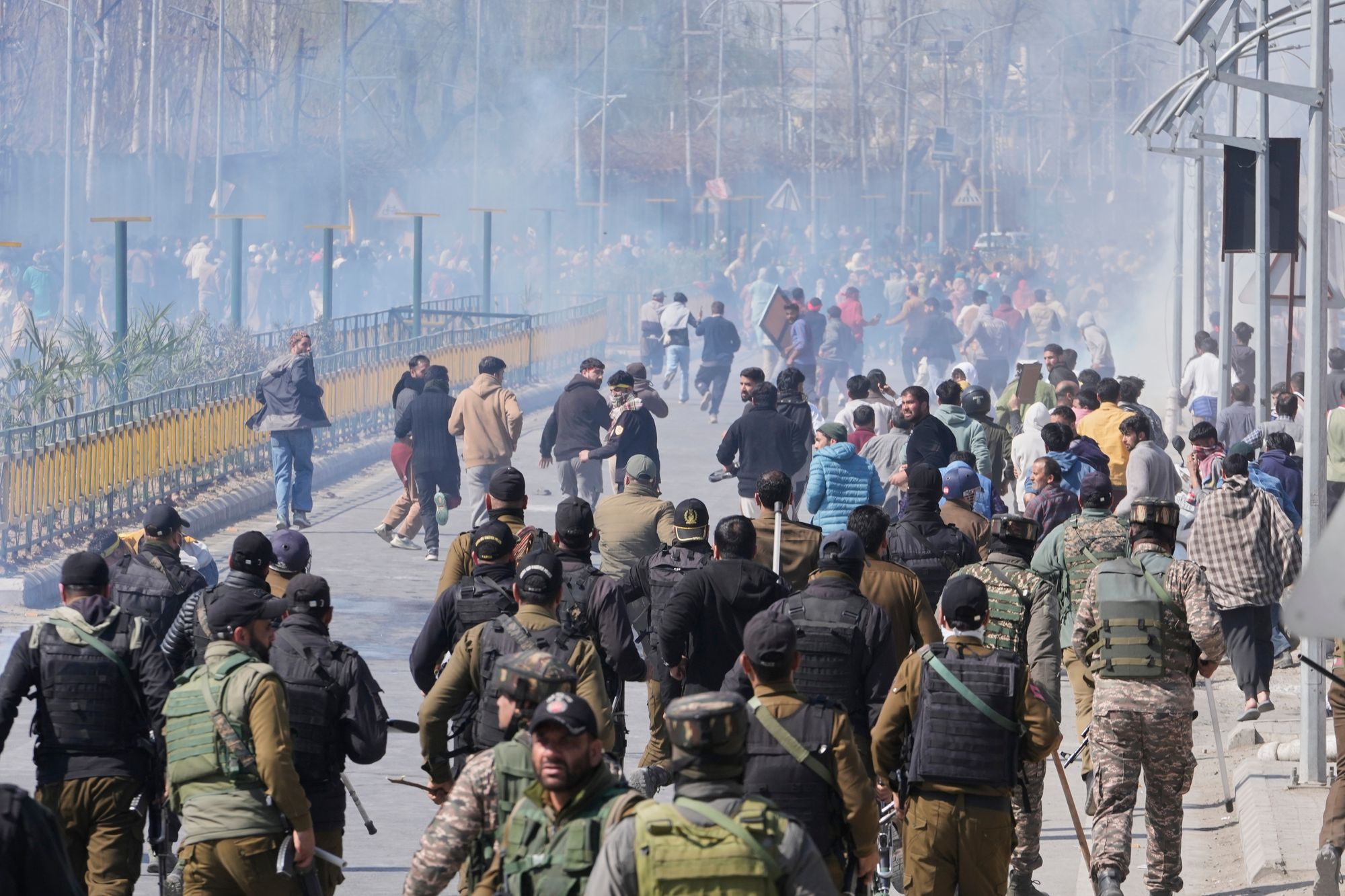 Shiite Muslims run for cover as Indian police use tear gas and batons during a protest against the killing of Iran's supreme leader Ayatollah Ali Khamenei, in Srinagar, Indian controlled Kashmir, Monday, 2 March 2026