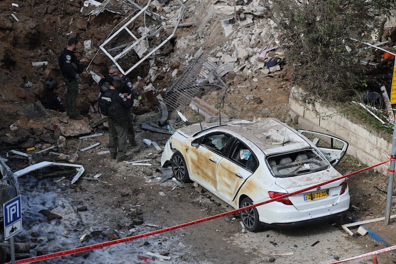 Israeli emergency service personnel gather at the site of an Iranian missile strike in Tel Aviv on Tuesday. Photo by Jack Guez/AFP via Getty Images