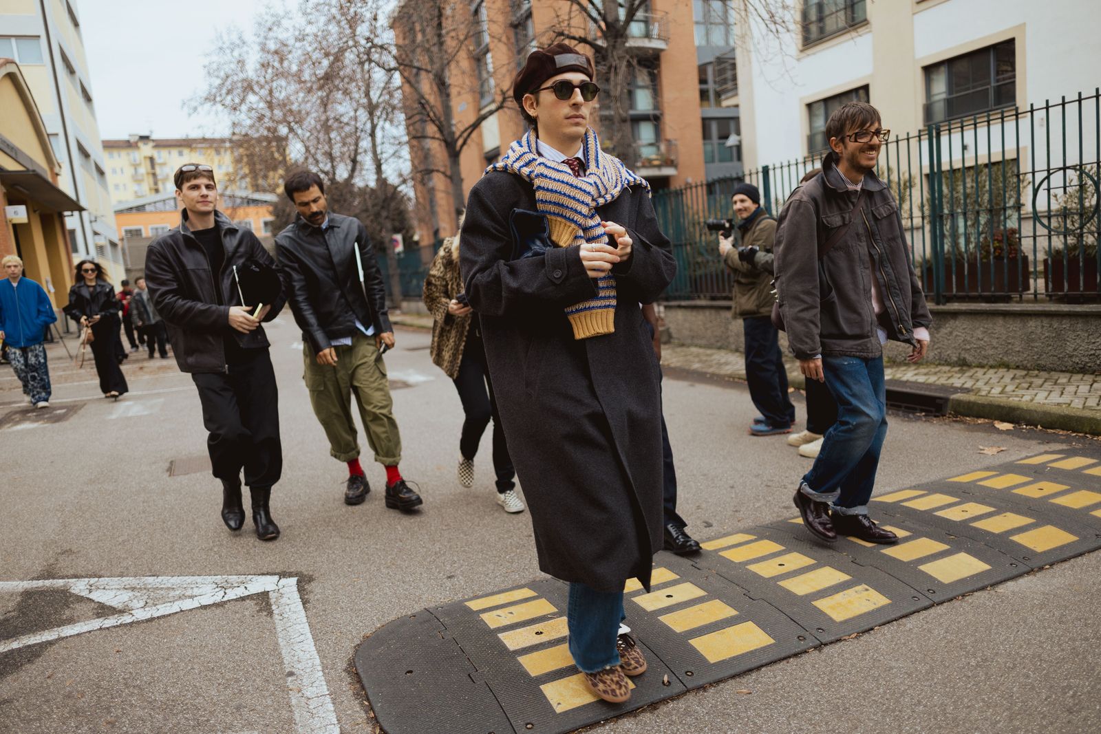 Image may contain Vasiliy Stepanov Bruce Baumgartner Pedestrian Person Clothing Coat Adult Jeans and Pants