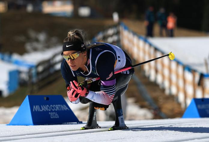 A female sit skier is racing