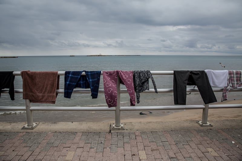 Clothing owned by displaced people hangs out to dry on the seafront in Saida, southern Lebanon. Photograph: Sally Hayden