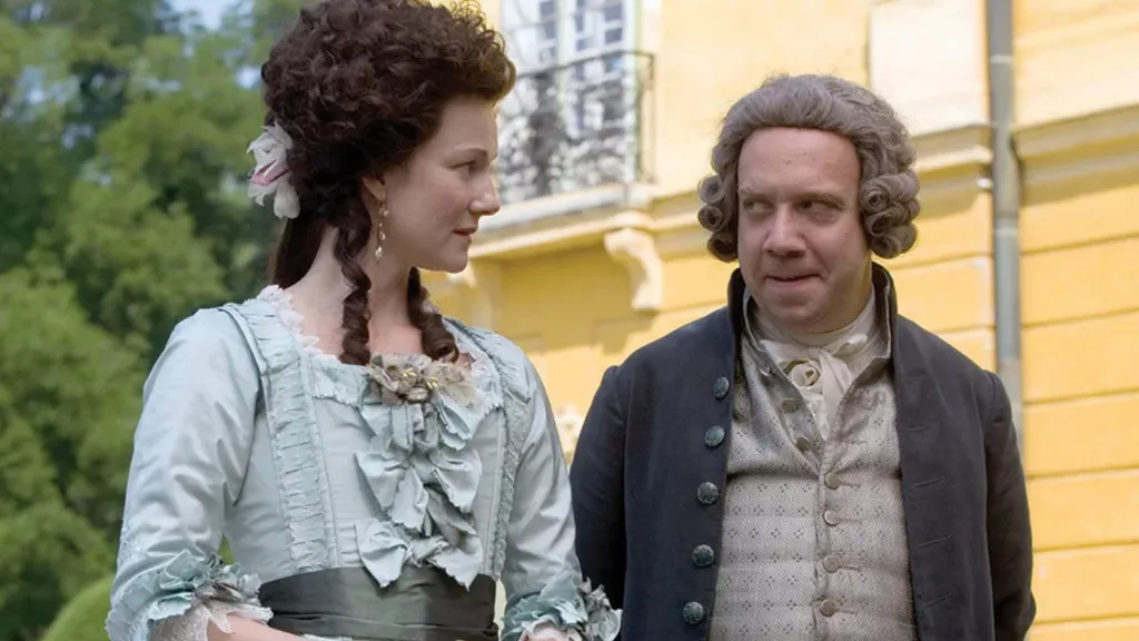Paul Giammati's John Adams stands beside Laura Linney's Abigail in HBO's John Adams 2008