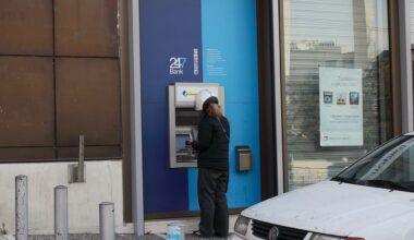 Person uses a bank's ATM in Greece