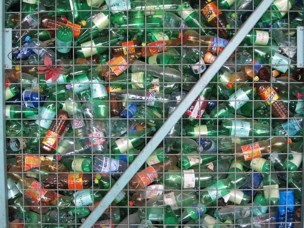 Plastic bottles recycling bin filled with discarded bottles for environmental sustainability.