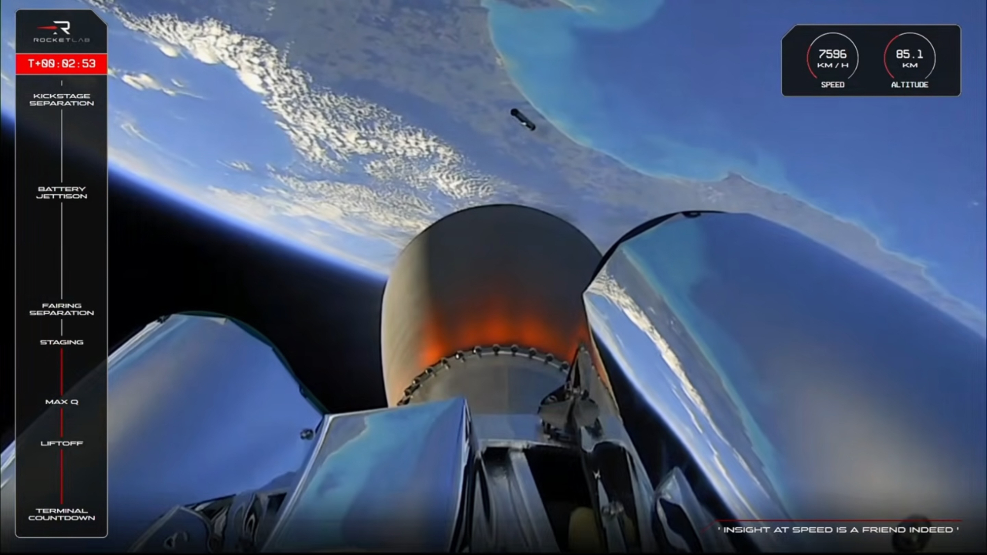 view from the upper stage of a rocket, showing an engine nozzle burning orange-hot in the foreground with earth in the background. the rocket's cylindrical first stage is visible falling back to earth