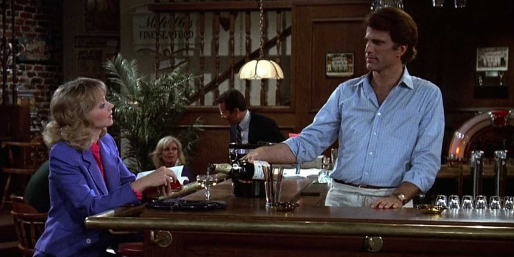 Ted Danson as Sam Malone and Shelley Long as Diane Chambers talking at the bar in Cheers