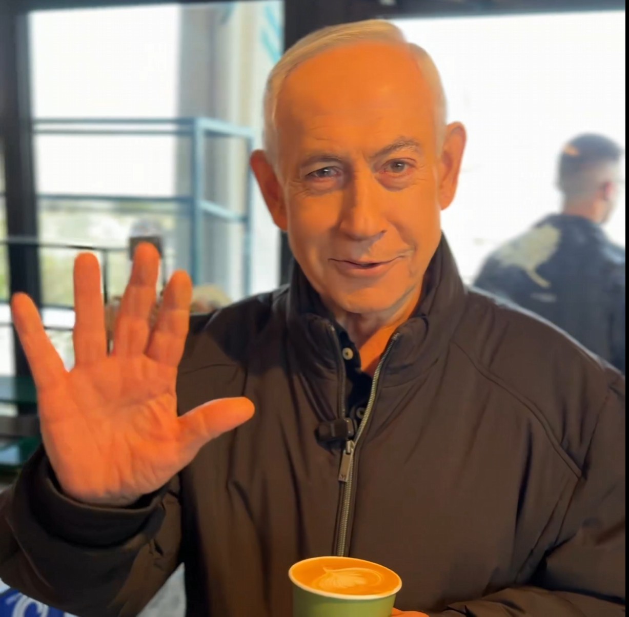 A screenshot taken from a social media video of Benjamin Netanyahu at a coffee shop.