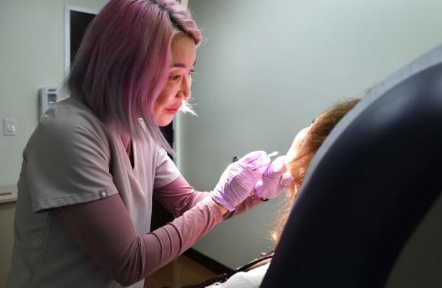 Shasa Hu, M.D., an Associate Professor at the University of Miami, performs an injection procedure on a patient in Miami on Friday, February 13, 2026. (Carline Jean/South Florida Sun Sentinel)
