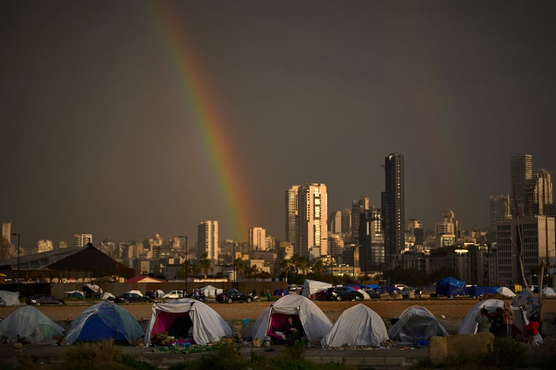 Displaced people who fled Israeli strikes in southern Lebanon sit inside tents near Beirut. Photograph: Emilio Morenatti/AP