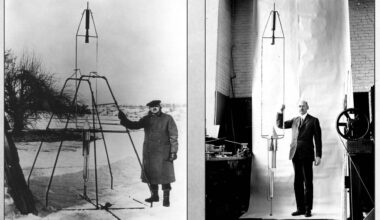 a man stands next to a tall wire frame cone-shaped object in a snowy field