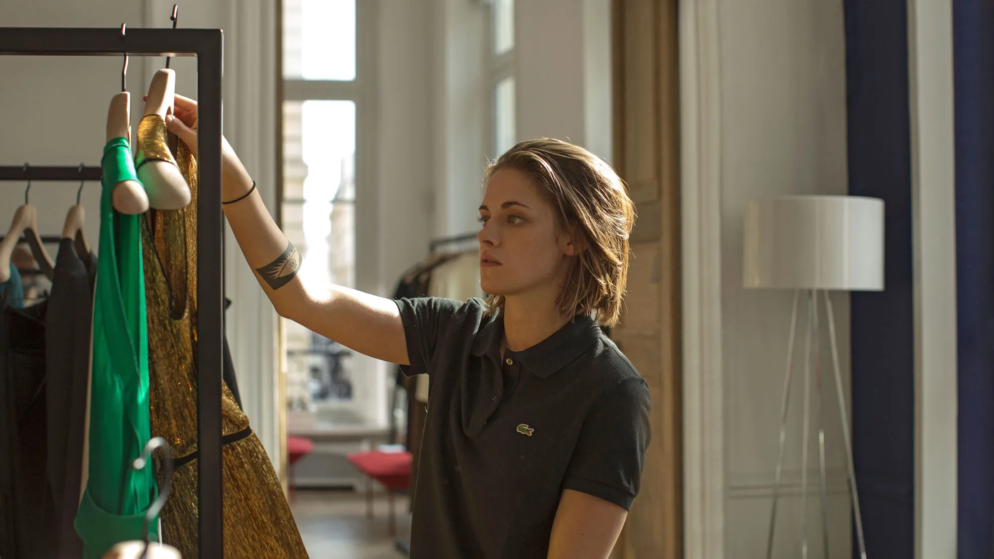 A young woman (Kristen Stewart) is shopping for clothes in the movie Personal Shopper.
