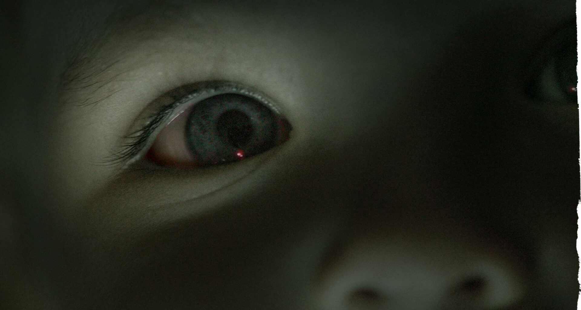 A close up of a child's eye that's blue. The image has a blue tint