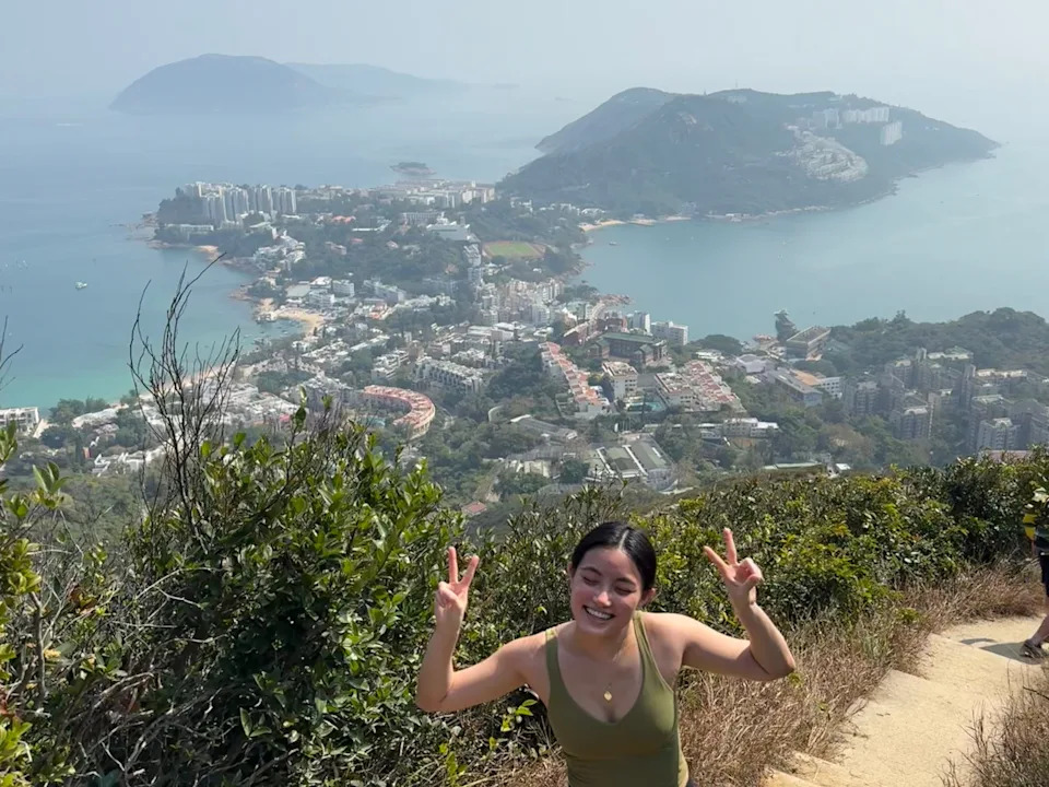 A woman hiking on a trail in Hong Kong.