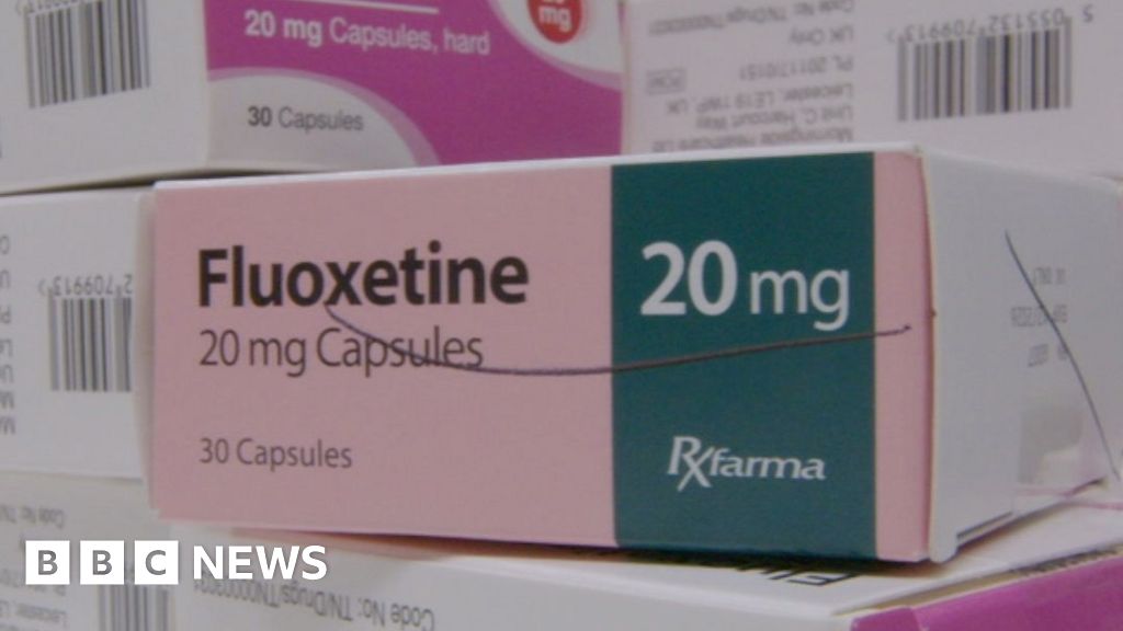 A stack of small boxes of medicine in a pharmacy setting