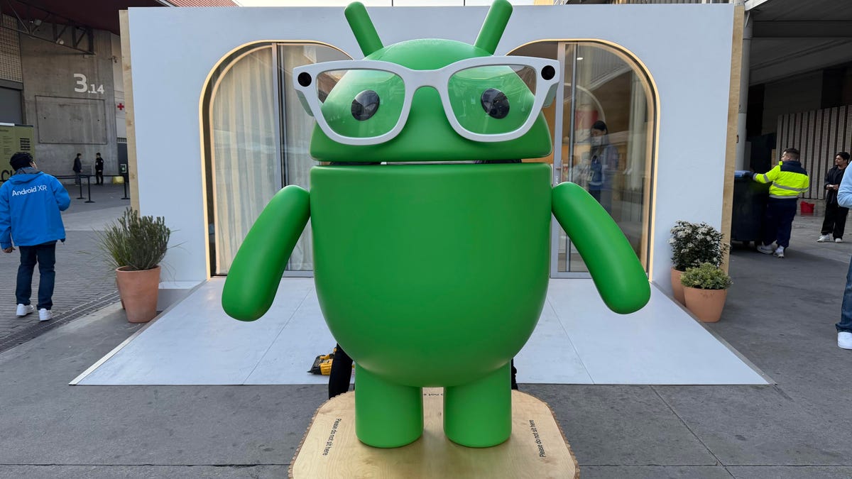 A green Android bot figure with smart glasses