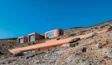 olen resort embeds into greek island slope across three terraced levels