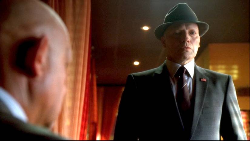 August (Peter Woodward), a man in a gray suit and tie with a small U.S. flag pin meets with another Observer in the Fringe episode "August"