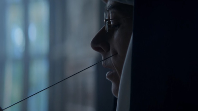 Mother Superior with a needle in her cheek in Peaky Blinders