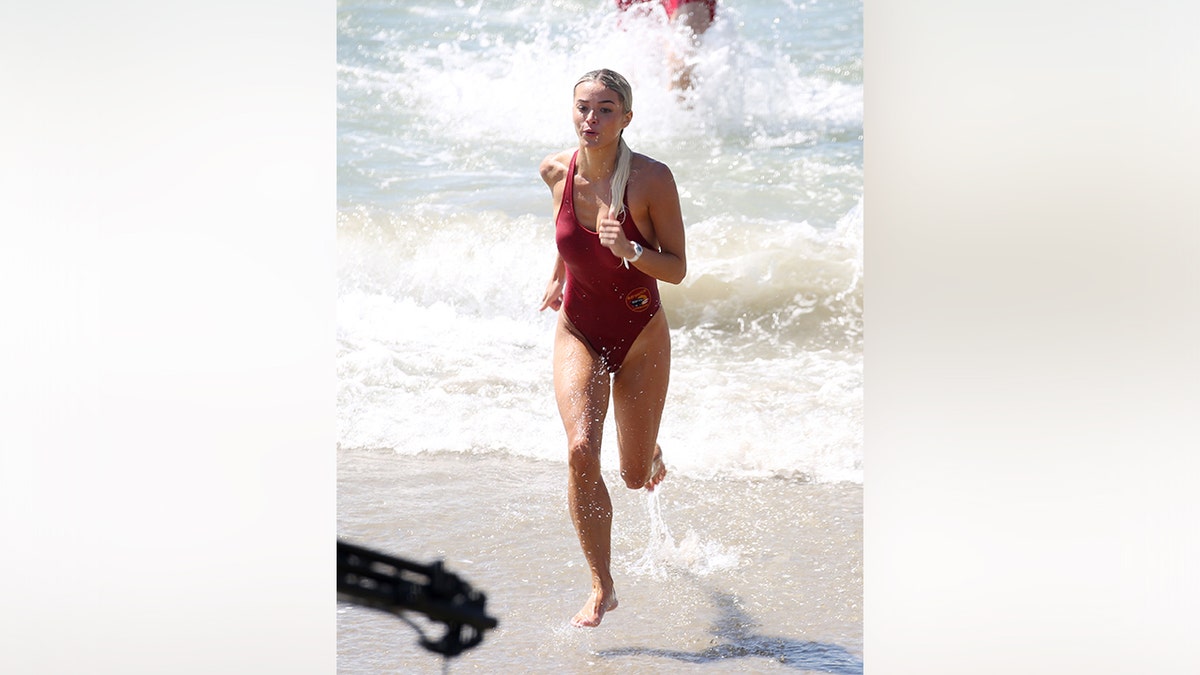 A cast member of the "Baywatch" reboot coming out of the water while filming.