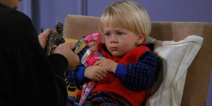 Ben plays with a Barbie doll in Friends