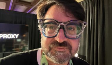 CNET editor Scott Stein wearing smart glasses over his own glasses at SXSW