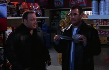 Two men in a store aisle; one holds duct tape. Both wear dark jackets