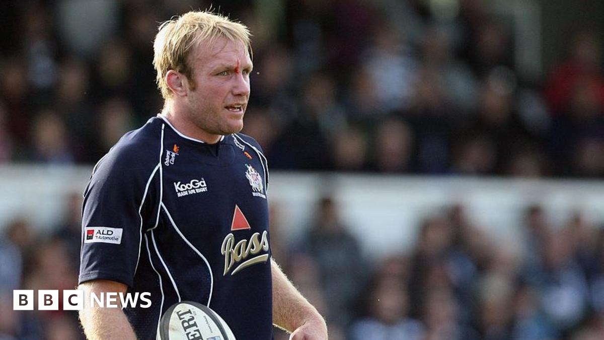 Matt Salter during a rugby match standing and holding the ball, he has a cut in the middle of his eyebrow