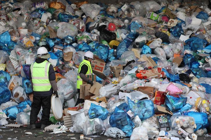 Piles of waste are stacked at a recycling sorting facility in Seoul. / Yonhap