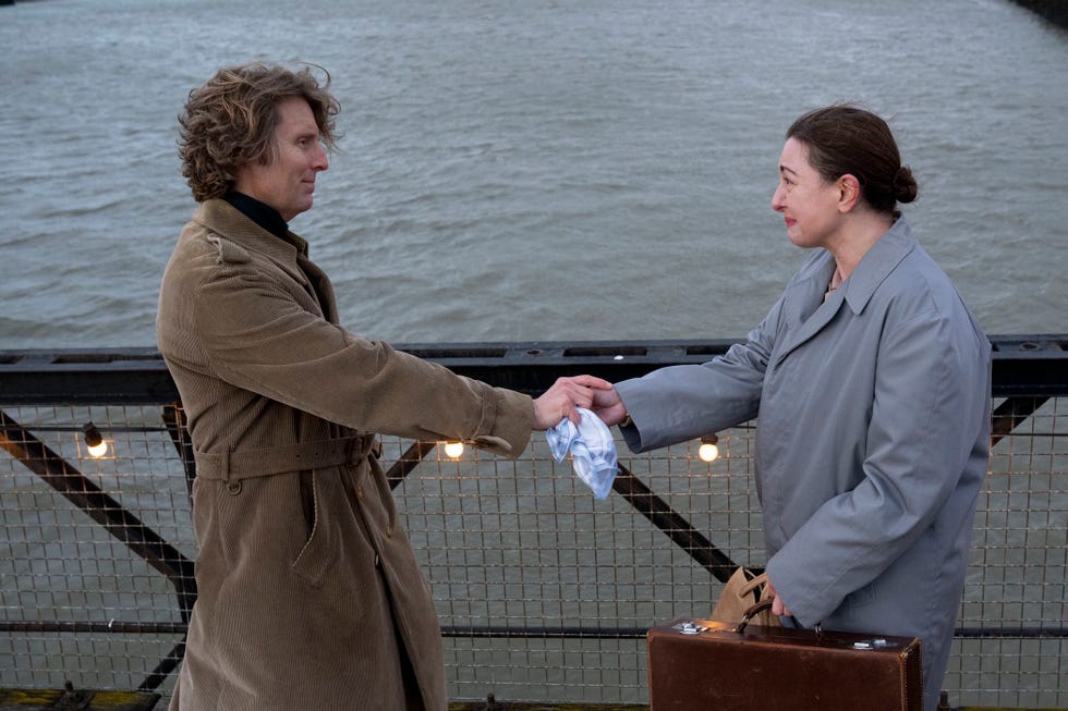 call the midwife rebecca gethings and christopher harper as sister veronica and geoffrey franklin holding hands in front of a river looking emotional