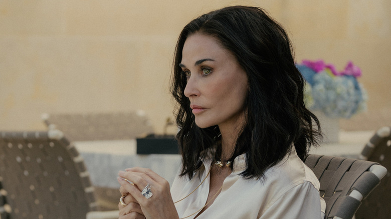 Cami holding her necklace in 