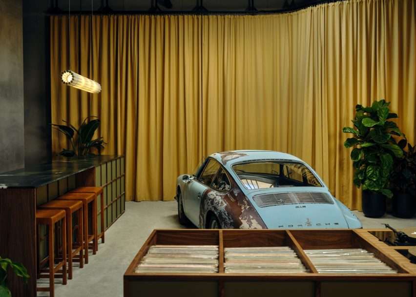 Car showroom and coworking space with a full-height mustard yellow curtain
