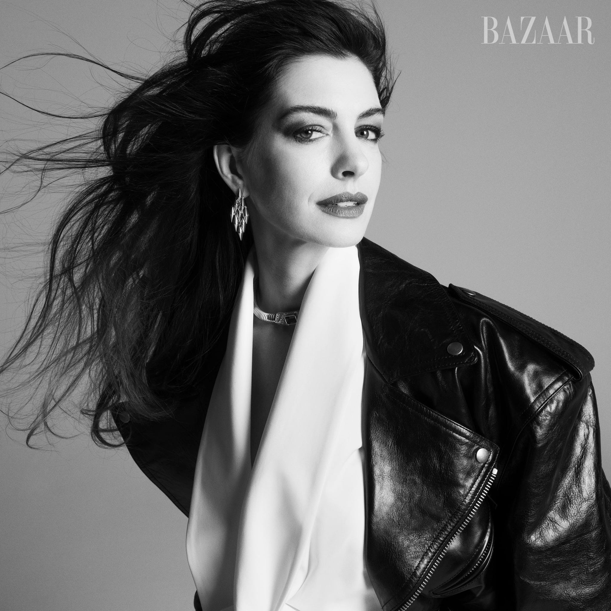 portrait featuring a figure with windswept hair wearing a leather jacket and accessories portrait featuring a figure with windswept hair wearing a leather jacket and accessories