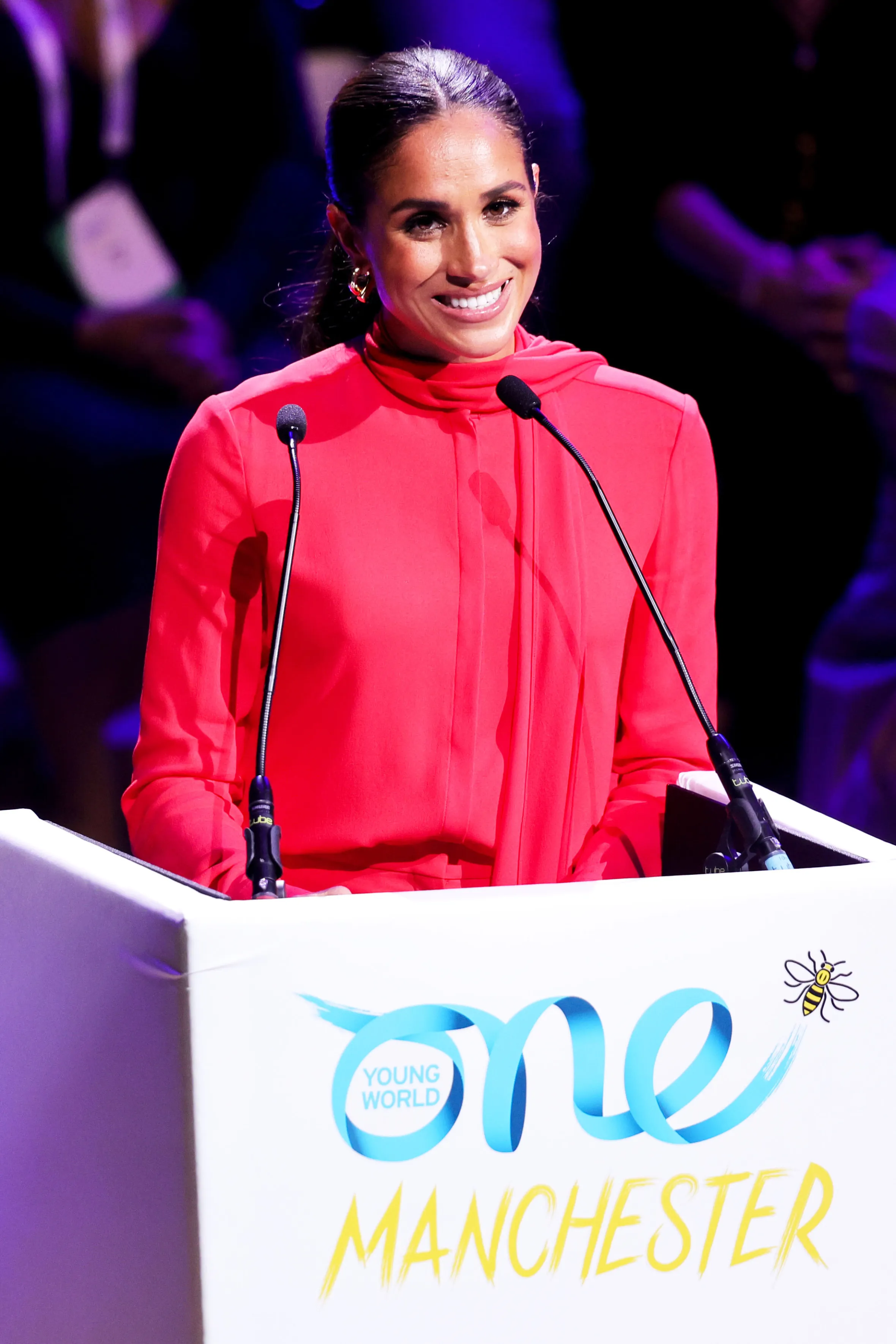 Meghan, Duchess of Sussex, smiling and giving a keynote speech at the One Young World Summit.