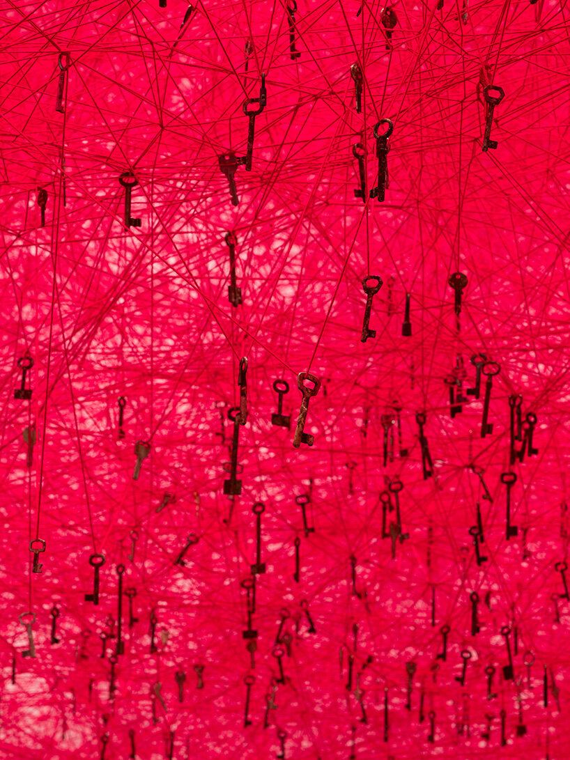 chiharu shiota's woven webs meet yin xiuzhen's clothing installations at hayward gallery - 5