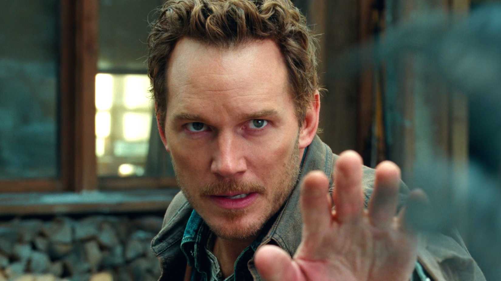 Chris Pratt in Jurassic World Dominion holding one hand out