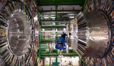 A person, center, right, is dwarfed by the size of the CMS experiment at the Large Hadron Collider, shown here in 2024. Credit: CMS/CERN
